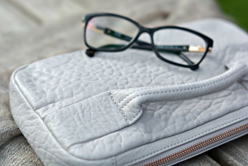 Carolina Herrera glasses | Alexander Wang pebble leather clutch