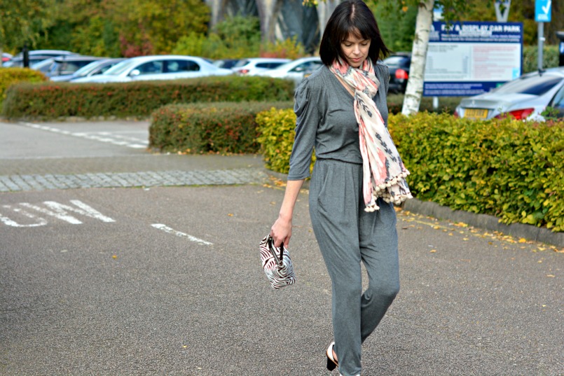 Sandro grey jumpsuit | Prada zebra pony hair bag | Whistles white two part sandal | All Saints Ikat pom pom scarf