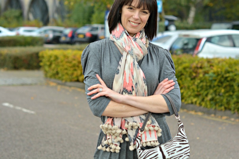 Sandro grey jumpsuit | Prada zebra pony hair bag | Whistles white two part sandal | All Saints Ikat pom pom scarf