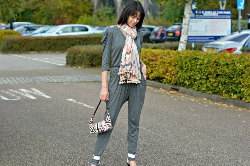 Sandro grey jumpsuit | Prada zebra pony hair bag | Whistles white two part sandal | All Saints Ikat pom pom scarf