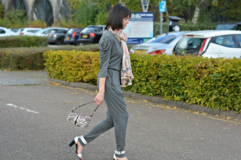 Sandro grey jumpsuit | Prada zebra pony hair bag | Whistles white two part sandal | All Saints Ikat pom pom scarf