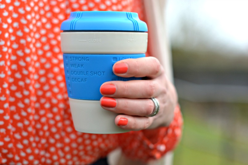 blue take away coffee cup and orange opi varnish