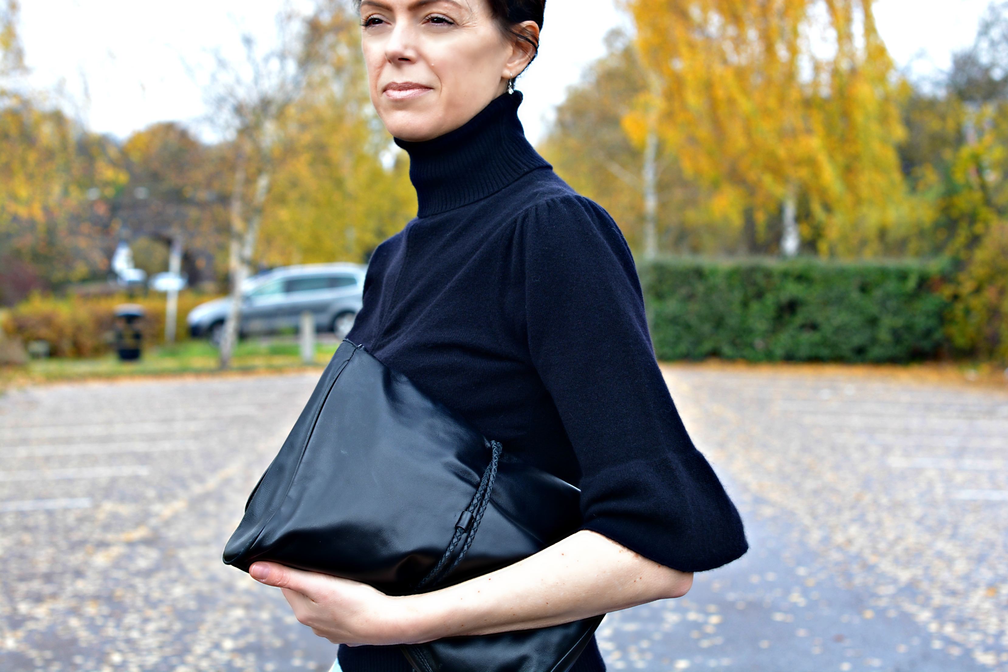 Wear hair in a bun with high neck polo neck jumper