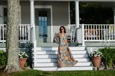 woman-walking-down-steps-wearing-floor-length-floral-dress-by-dodobaror-what-is-intersectional-environmentalism-3-pillars-of-sustainability