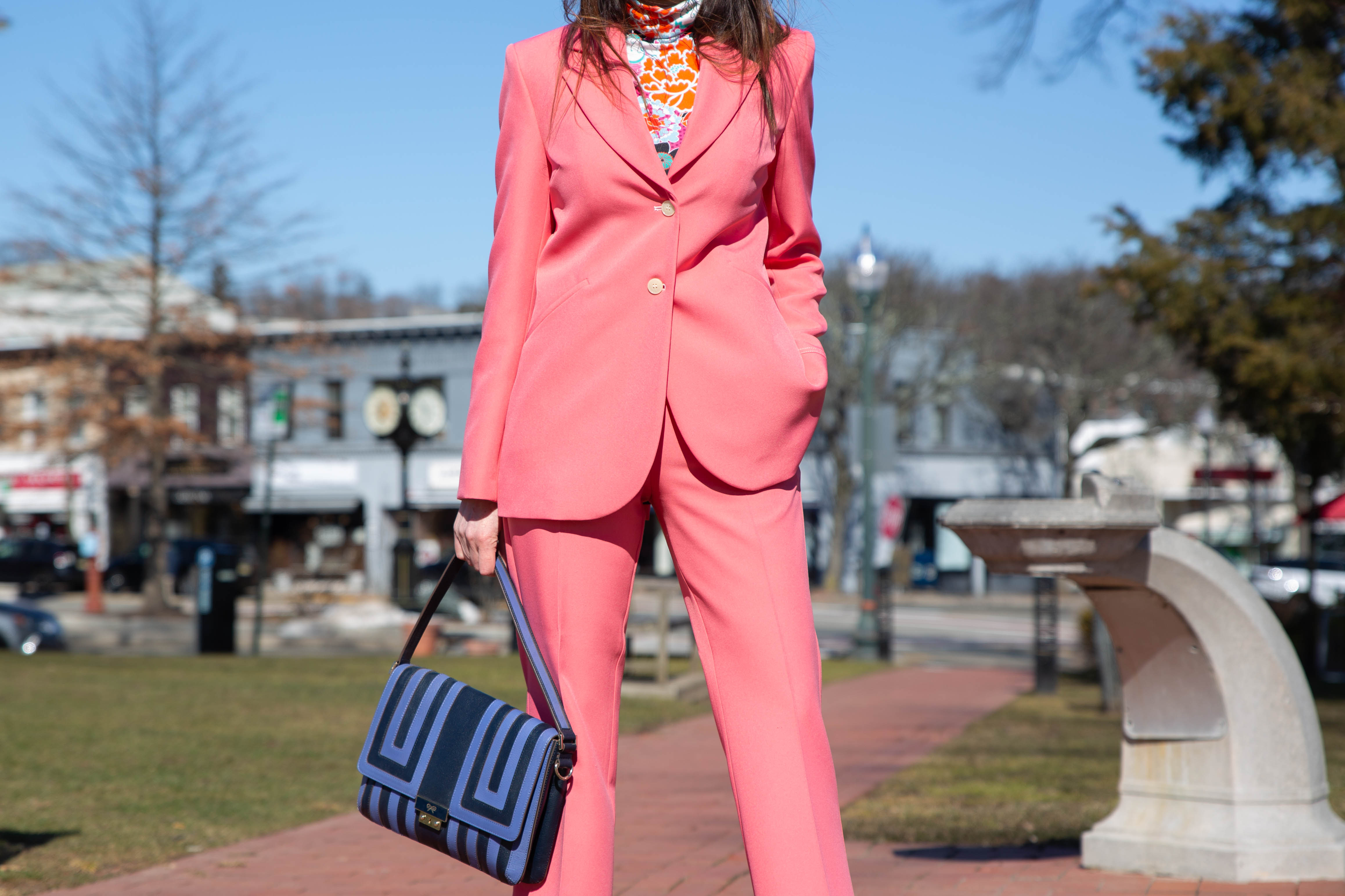 conscious citizen wears bright pink suit by stine goya worn with bright floral turtle neck top 